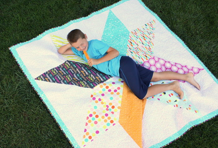 Summer poser on a quilt