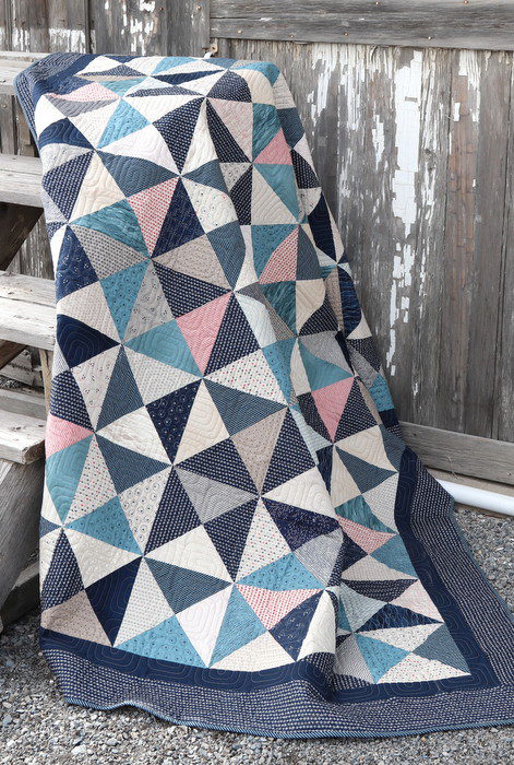 Hour Glass Layer Cake Quilt pattern in indigo and tan color shades.