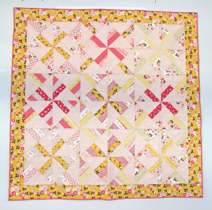 Free Video Class: Strip Piecing Quilt Patterns by popular Utah quilting blog, Diary of a Quilter: image of an hourglass pinwheel quilt.