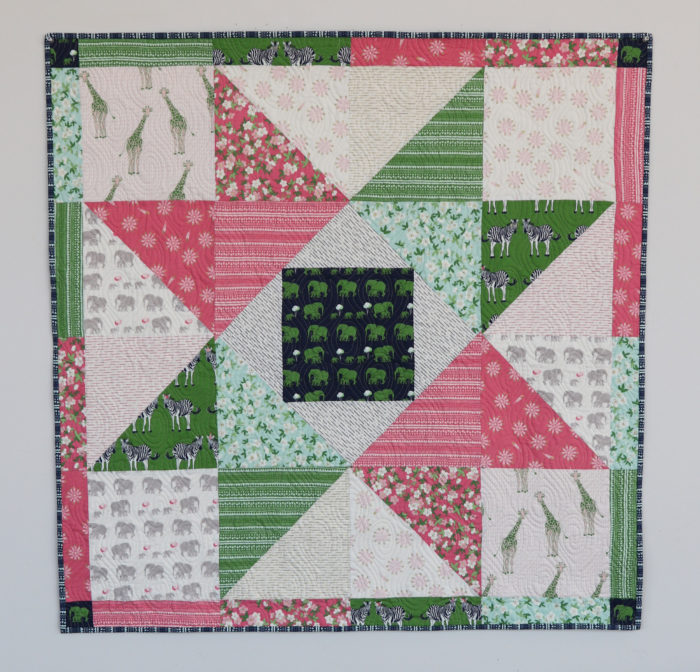 Patchwork Baby Quilt tutorial by Amy Smart, Diary of a Quilter. Fabric = Safari Party by Melissa Mortenson for Riley Blake Designs.
