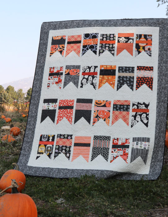"Halloween Bunting” is a Free Halloween Hallooween Lap Quilt Pattern designed by Amy Smart from Diary of a Quilter!