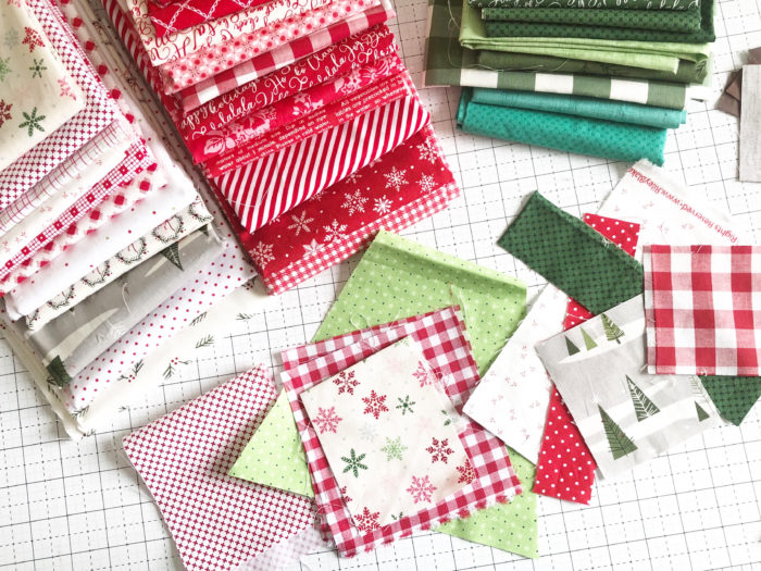 New Patchwork Forest Quilt Pattern: Pine Hollow Version by popular quilting blog, Diary of a Quilter: image of a red, white, and green Christmas fabric blocks.