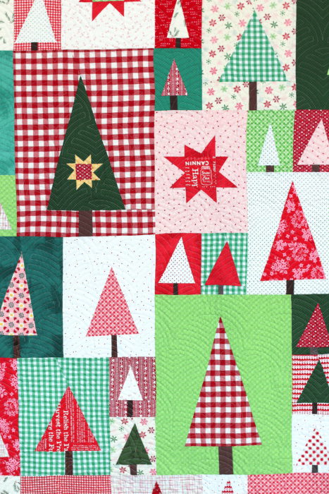 New Patchwork Forest Quilt Pattern: Pine Hollow Version by popular quilting blog, Diary of a Quilter: image of a red, white, and green patchwork forest tree quilt.