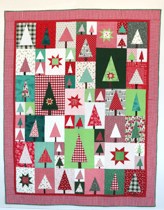 New Patchwork Forest Quilt Pattern: Pine Hollow Version by popular quilting blog, Diary of a Quilter: image of a red, white, and green patchwork forest tree quilt.