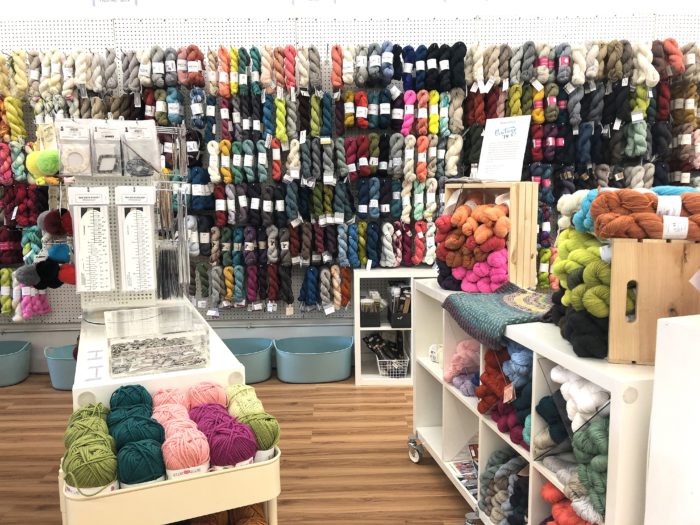 Pintuck & Purl - Modern Fabric and Knitting Shop by popular quilting blog, Diary of a Quilter: image of various yarn displays inside Pintuck and Purl.