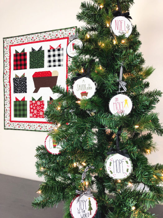 Christmas in July - Hand Stitched Christmas Ornament Tutorial by popular sewing blog, Diary of a Quilter: image of hand stitched Christmas ornaments hanging on a Christmas tree.