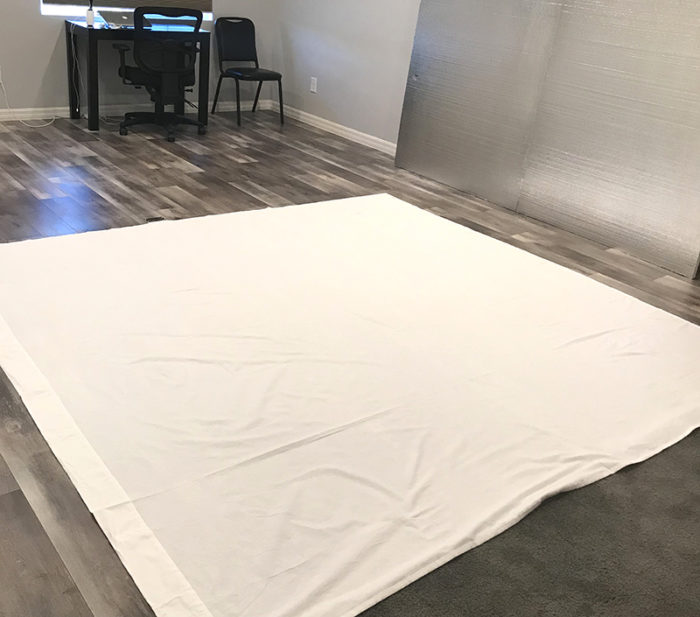 How to Build a Quilt Design Wall by Christa Watson by popular quilting blog, Diary of a Quilter: image of two foam core insulation boards covered in a king size white flannel sheet.
