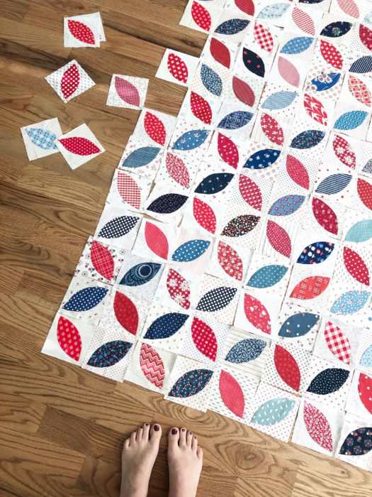 Red and Blue + Low Volume Orange Peel applique blocks | More Orange Peel Applique Blocks + Real Life by popular Utah quilting blog: Diary of a Quilter: image of orange peel applique blocks laid out in a patter on a hard wood floor.