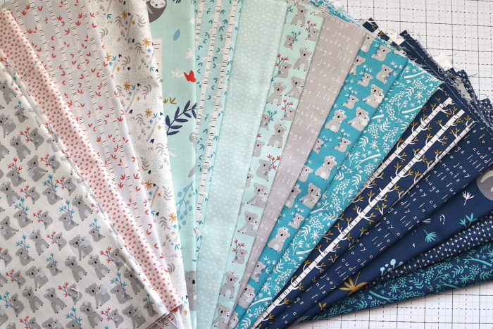 Bricks Baby Quilt Tutorial by popular quilting blog Diary of a Quilter: image of various fat quarters and strips of fabric.