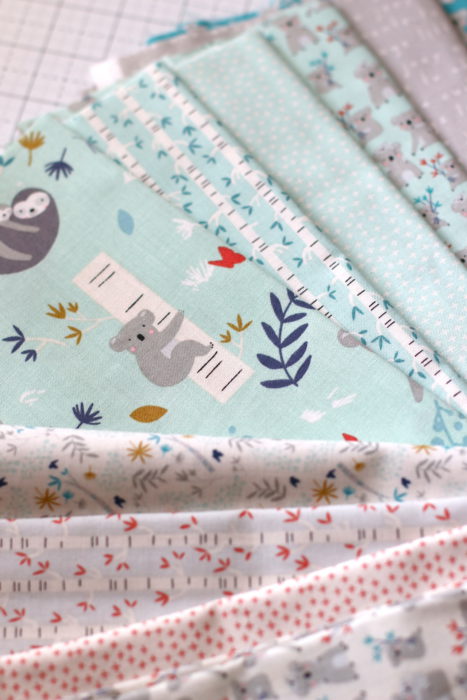 Bricks Baby Quilt Tutorial by popular quilting blog Diary of a Quilter: image of various fat quarters and strips of fabric.