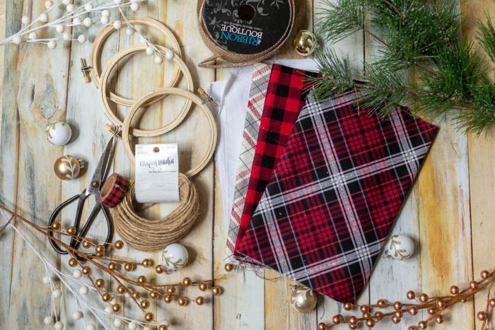 DIY Heirloom Christmas Ornament guest post by Coral + Co by popular Utah quilting blog, Diary of a Quilter: image of embroidery hoops, fabric scissors, plaid flannel fabric, twine, and plaid tape.