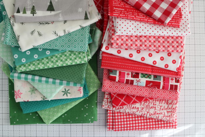 Welcome to the Patchwork Forest Quilt Along! by popular quilting blog, Diary of a Quilter: image of a various red, white, and green Christmas fabrics.