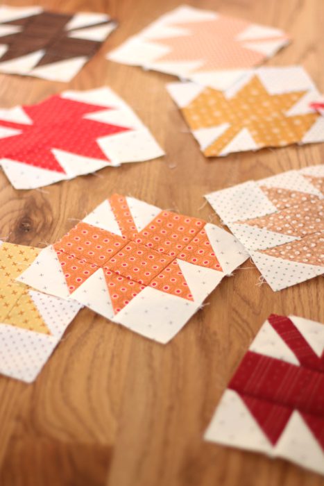 Classic Maple Leaf Quilt Block Tutorial by popular Utah quilting blog, Diary of a Quilter: image of individual maple leaf quilt blocks spread out on a table.