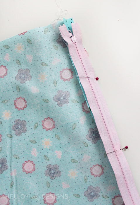Quilted Butterfly Reading Pillow by Guest Host Melanie Collette by popular quilting blog, Diary of a Quilter: image of blue floral fabric and a pink zipper.