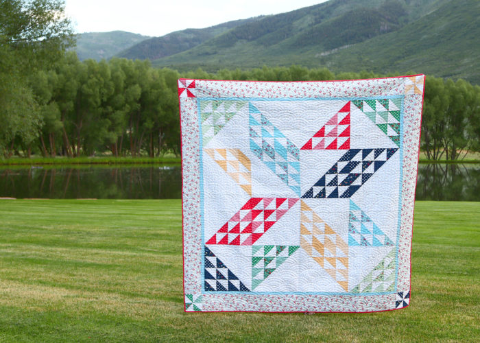 Brand new quilt pattern: Sugarhouse Star by popular Utah quilting blog, Diary of a quilter: image of a star quilt being help up outside by someone