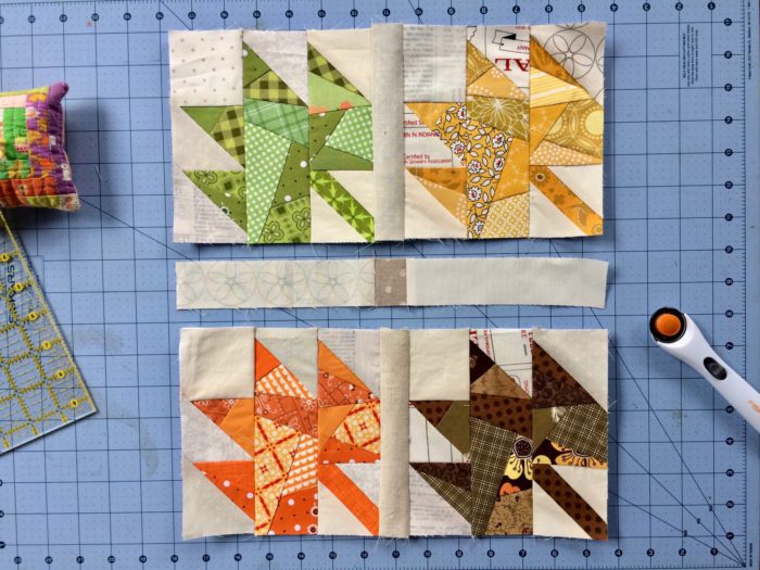 Scrappy Maple Leaf Quilt Pattern Tutorial by guest writer Leila Gardunia by popular quilting blog, Diary of a Quilter: image of scrappy maple leaf quilt blocks on a cutting board next to a rotary cutter. 