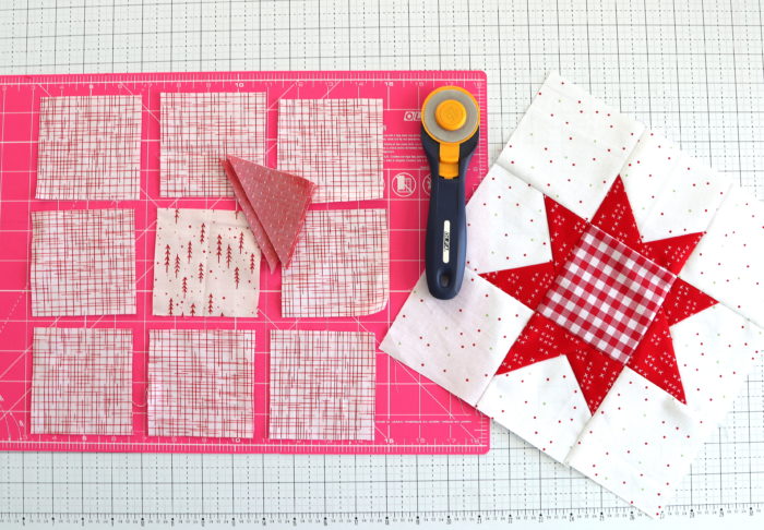 How to make a Wonky Star Quilt Block | Pine Hollow Patchwork Forest Quilt Along Week 4 by popular Utah quilting blog, Diary of a Quilter: image of a wonky star quilt block, cutting board and rotary cutter. 
