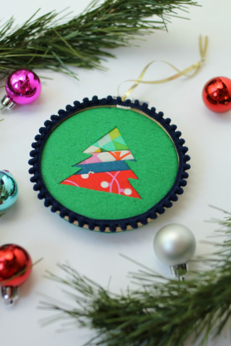 Felt Tree Ornament Tutorial by guest Stephanie of Swoodson Says by popular quilting blog, Diary of a Quilter: image of a felt tree ornament, some pine tree boughs, and small ball Christmas ornaments. 
