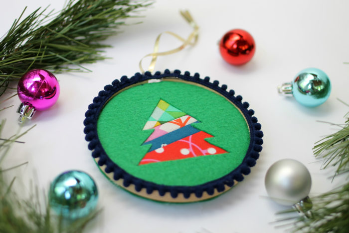 Felt Tree Ornament Tutorial by guest Stephanie of Swoodson Says by popular quilting blog, Diary of a Quilter: image of a felt tree ornament, some pine tree boughs, and small ball Christmas ornaments. 