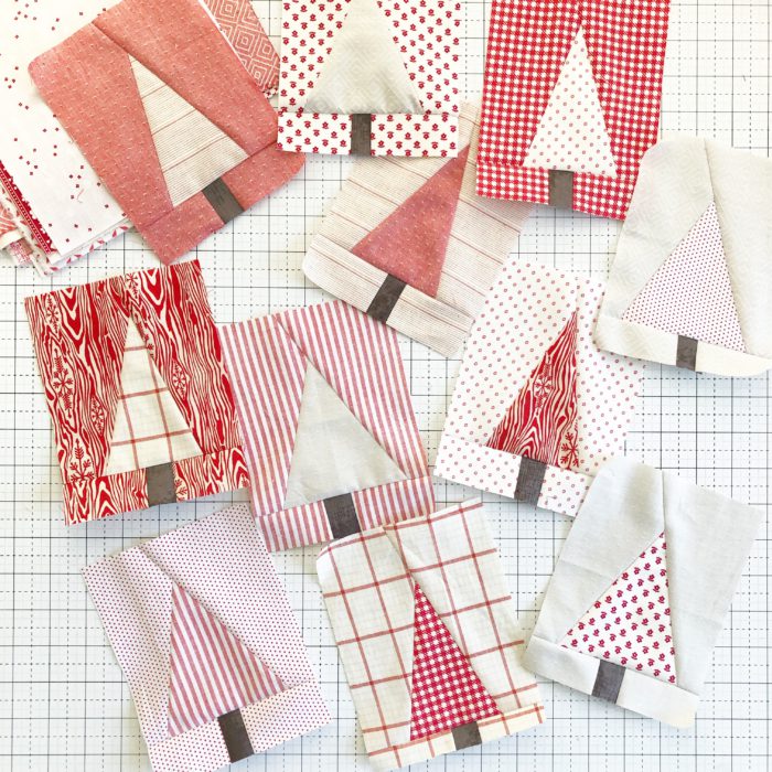 Pine Hollow Patchwork Forest Quilt Along Week 3 by popular quilting blog, Diary of a Quilter: image of red and white pine tree fabric squares. 