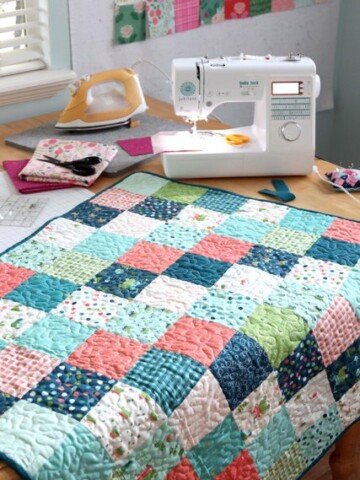 How to Make a Patchwork Baby Quilt with Precuts, a tutorial featured by top US quilting blogger, Diary of a Quilter