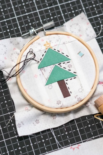 Handmade Christmas Tree ornaments with pieced flying geese blocks framed with a simple embroidery hoop.