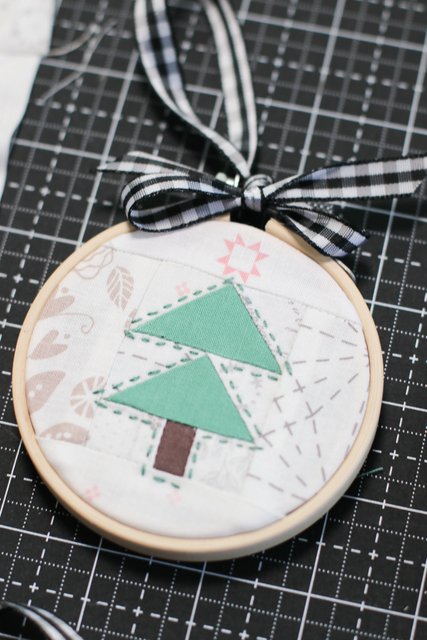 Handmade Christmas Tree ornaments with pieced flying geese blocks framed with a simple embroidery hoop.