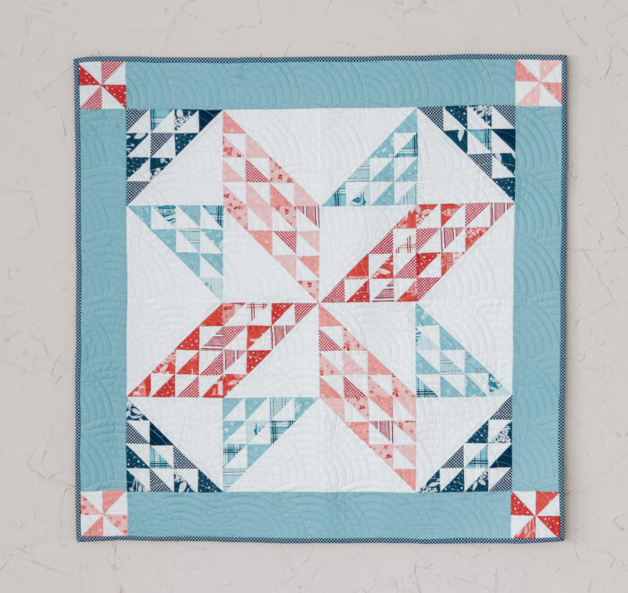 Traditional patchwork star baby quilt - Sugarhouse Star pattern by Amy Smart featuring the Portsmouth fabric collection.