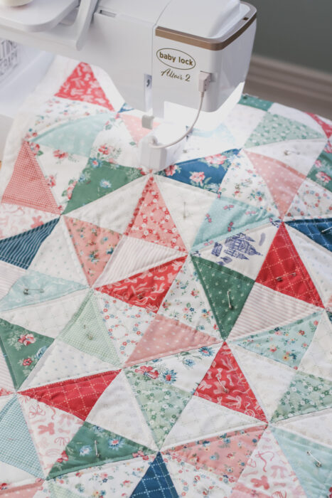 Straight-line quilting stitches being sewn on a quilt with a walking foot on a home sewing machine