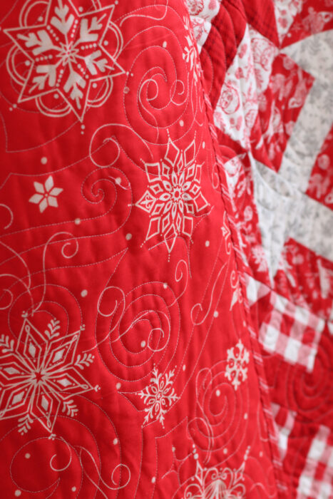 Red and White snowflake quilt back.