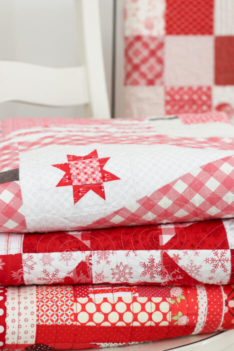 Stack of Red and white quilts made by Amy Smart