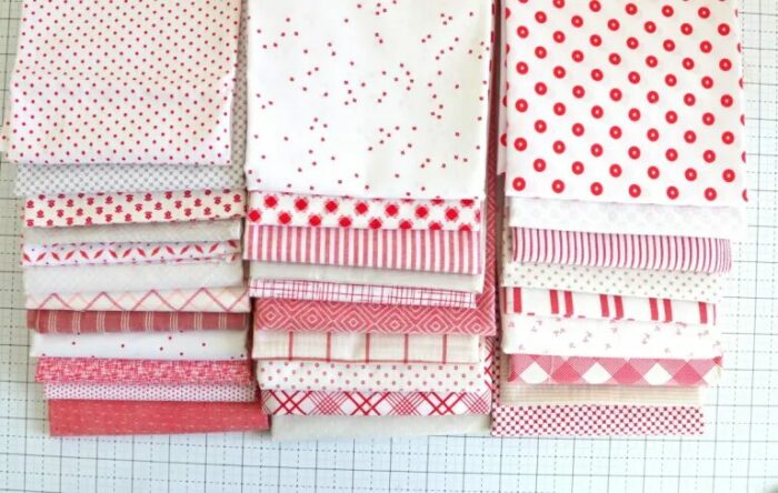 Fabric swatches for a washed-out, beachy red and white quilt