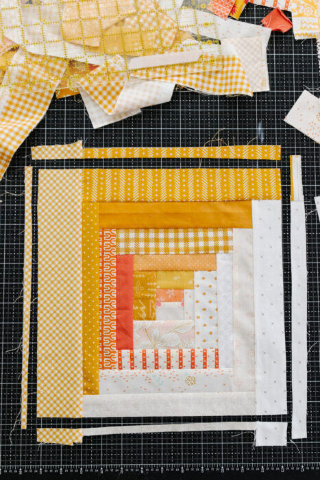 Square-up a scrappy improv-style Log Cabin quilt block made with scraps