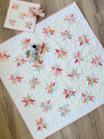Scrappy crib quilt made with FPP Woven Star Quilt blocks.