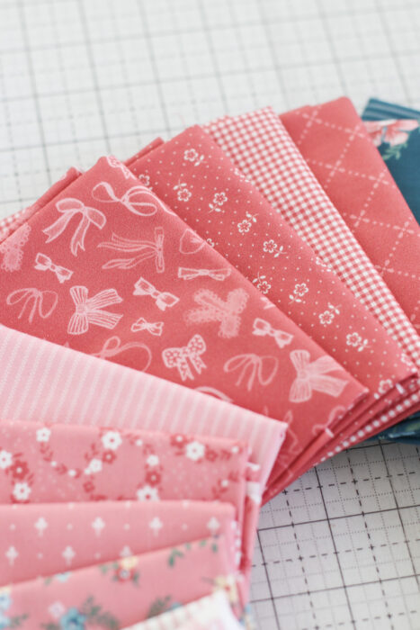 A bundle of red fabric of the Mary Catherine collection by Amy Smart for Riley Blake Designs.