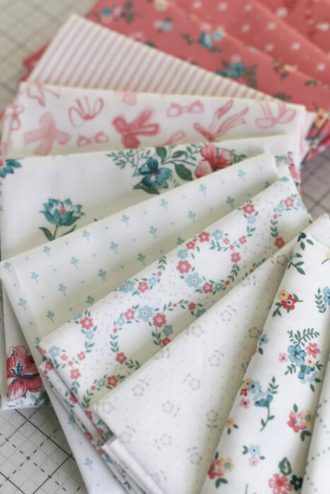 A bundle of white, low-volume fabric of the Mary Catherine collection by Amy Smart for Riley Blake Designs.