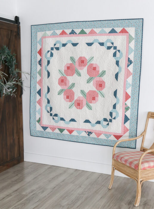 Briarcreek Blooms throw-size quilt with rosebud wreath center and patchwork borders using Mary Catherine fabric collection