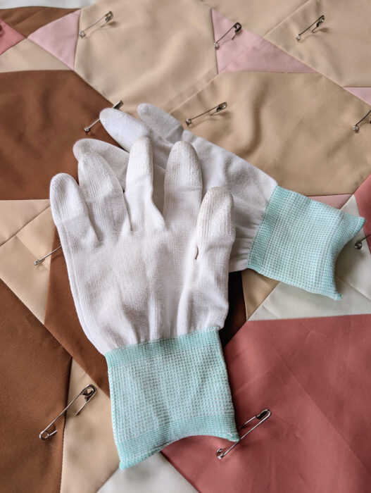 Use specialty quilting gloves for better grip on your quilt when machine quilting