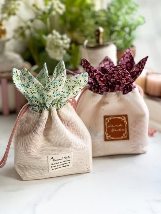 Colorful fabric drawstring pouches in various sizes and prints.