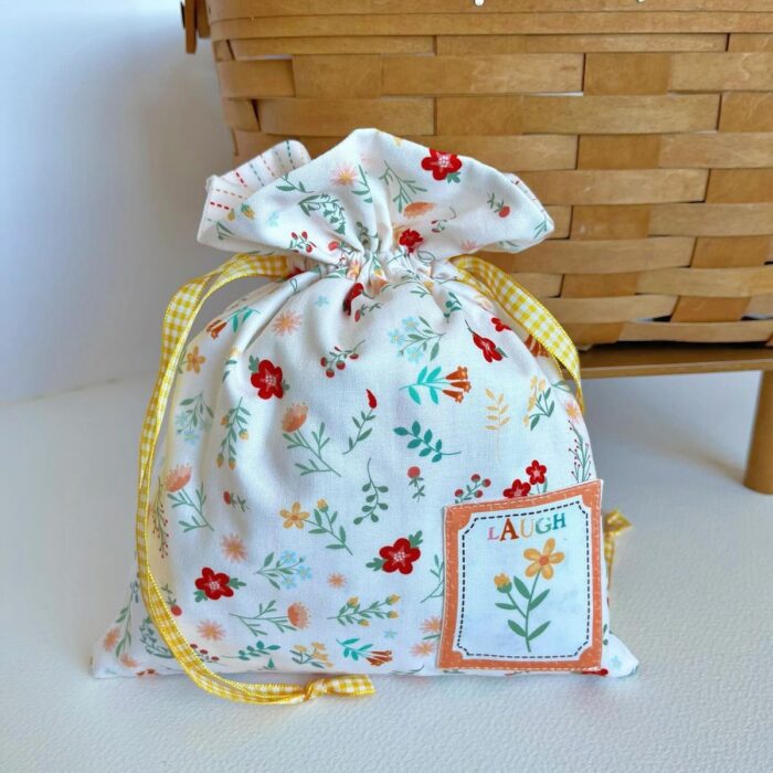 Colorful fabric drawstring pouches in various sizes and prints.