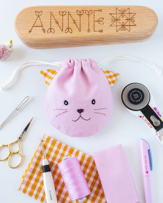 Colorful fabric drawstring pouches in various sizes and prints.