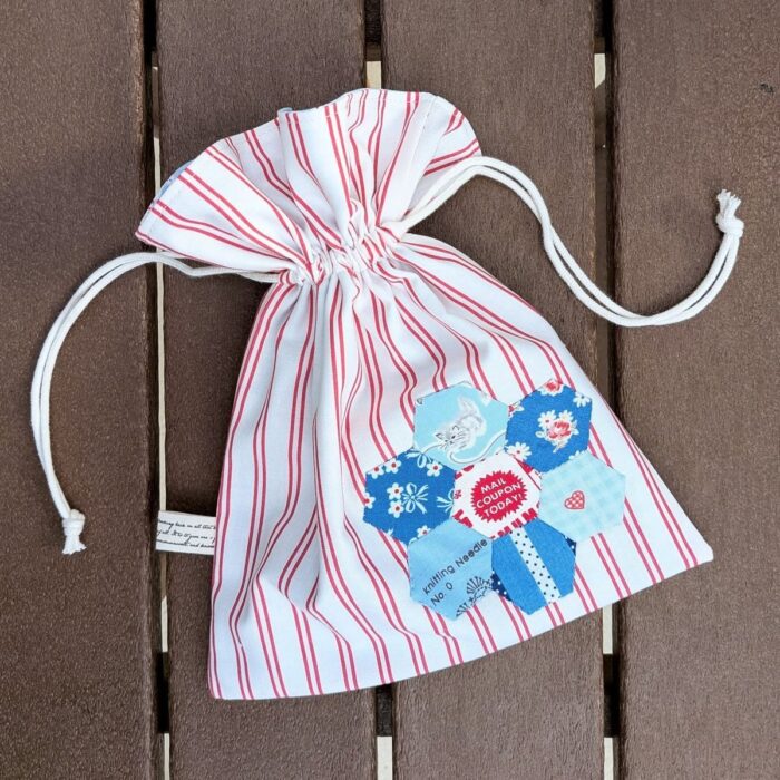 Colorful fabric drawstring pouches featuring epp hexagon applique