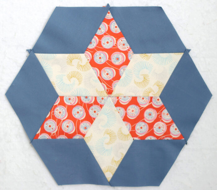 Six-pointed star quilt block made from 60-degree diamond pieces in light and dark fabrics