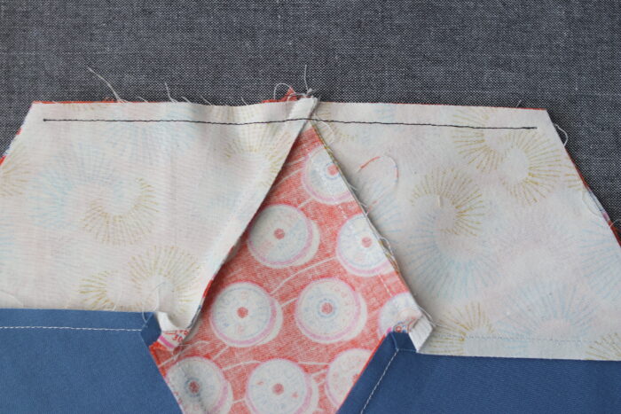 Two halves of a diamond star quilt block before joining at the center seam.
