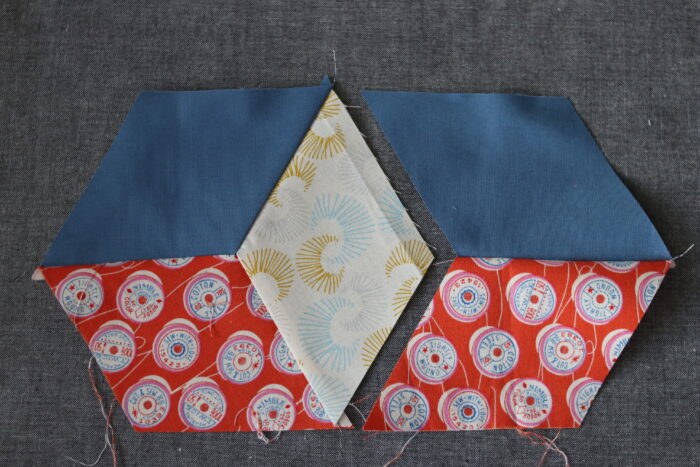 Sewing Y-seams to join 60-degree diamond quilt pieces into a star block.