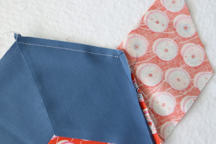 Sewing Y-seams to join 60-degree diamond quilt pieces into a star block.
