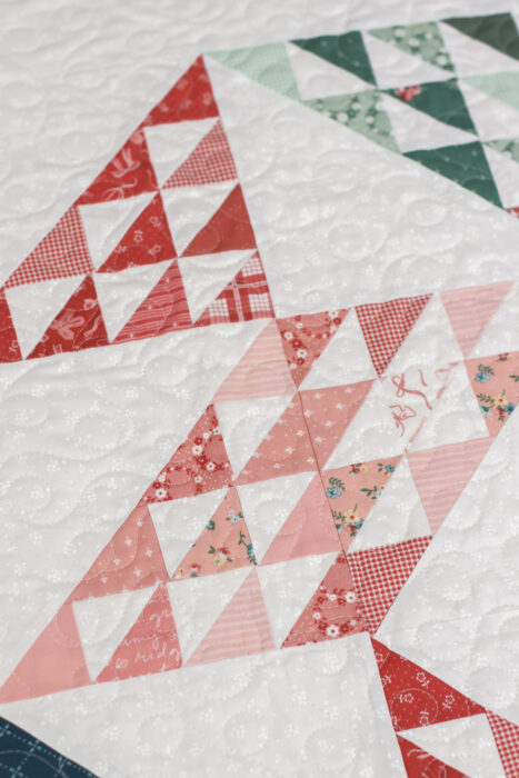 Sugarhouse Star baby quilt hanging flat, crisp star points, soft pastel prints from Mary Catherine collection on tonal Riley Blake white print