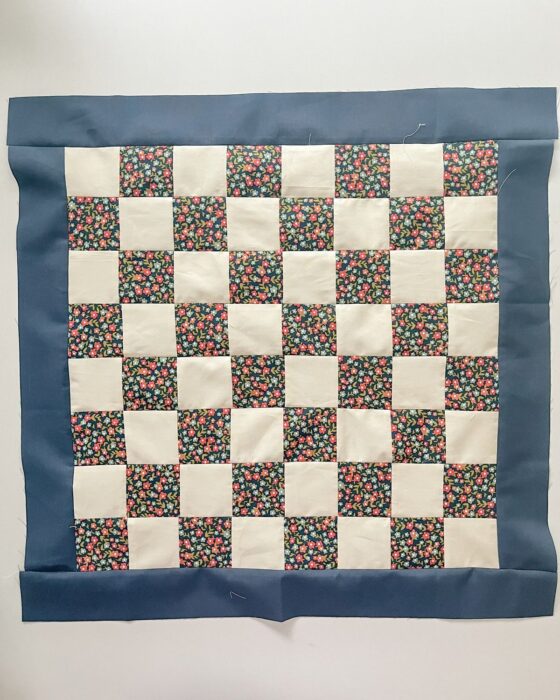 Finished 20″ × 20″ checkerboard block with borders pressed flat.