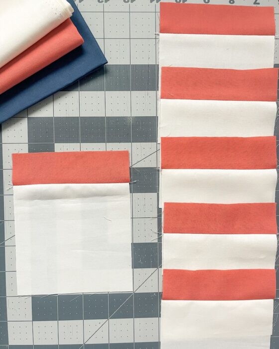 Short Fabric C strips sewn to the tops of background squares
