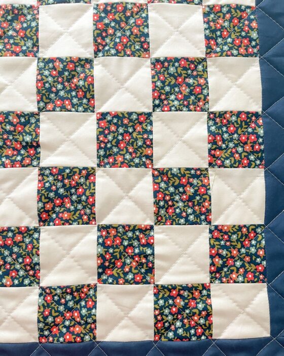 Completed 22″ × 22″ tic-tac-toe block with outer background borders.